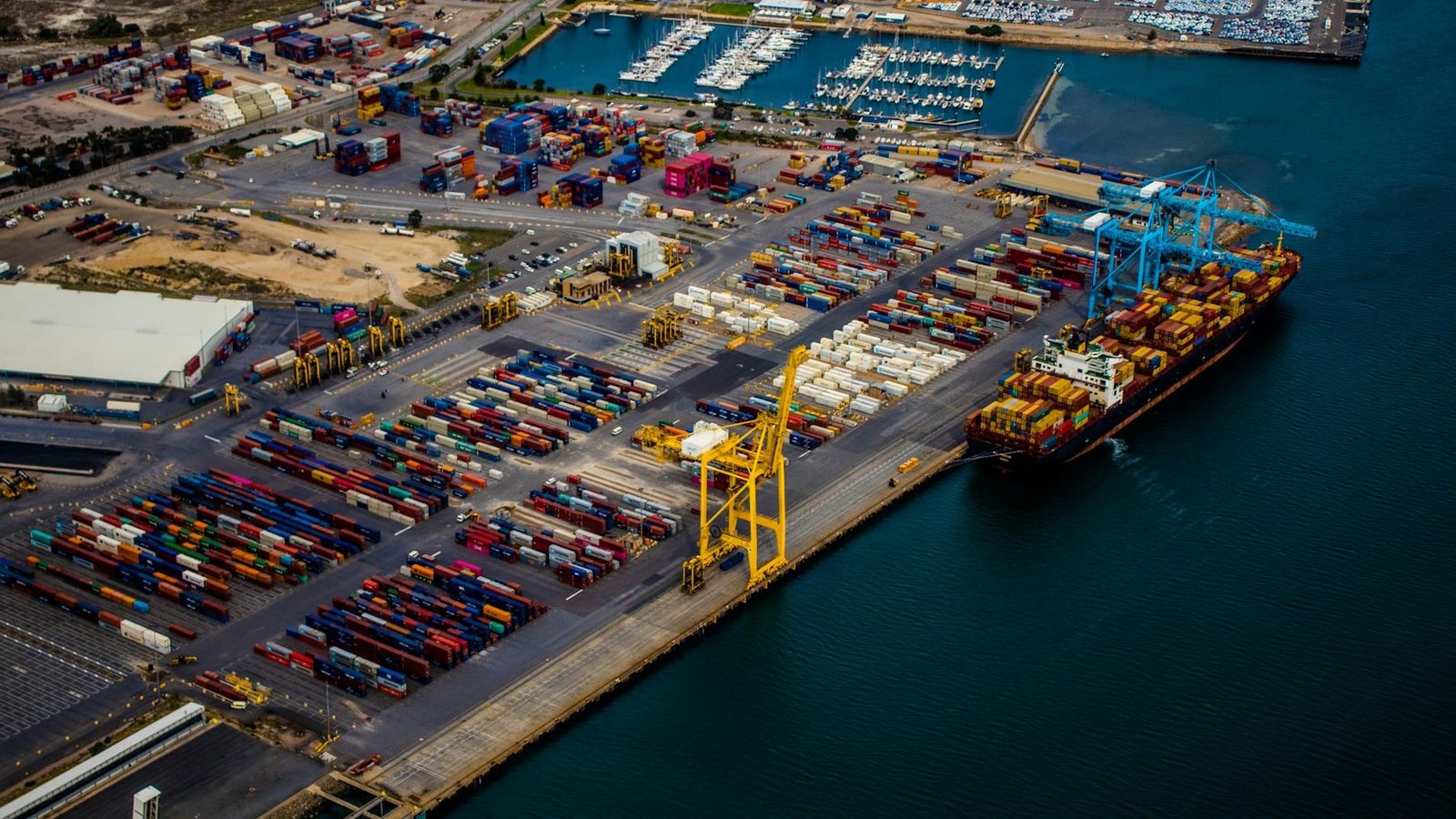 Aerial view of a container ship docked at a busy port