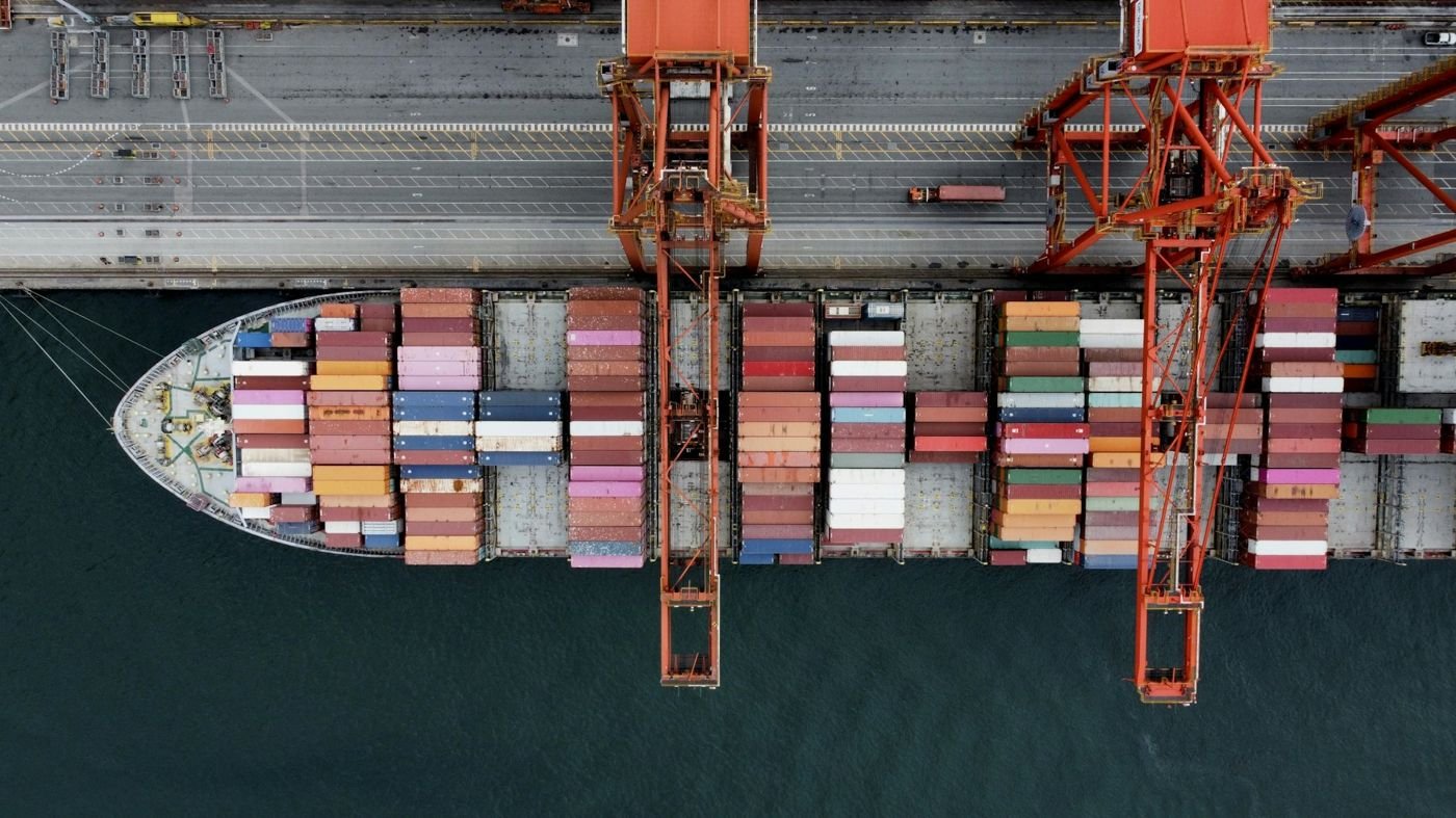 Container ship under cranes, seen from above
